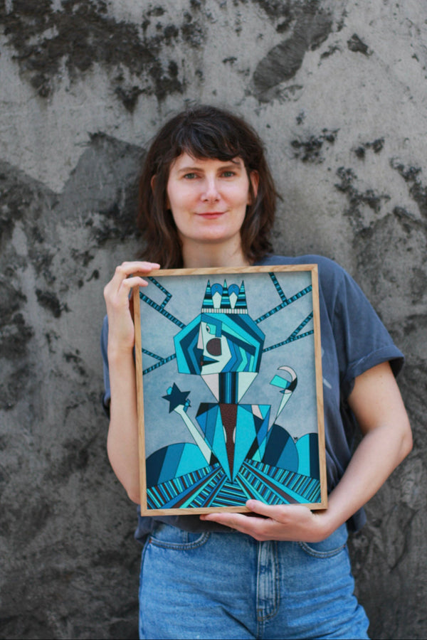 Woman holding a framed artwork against a textured wall